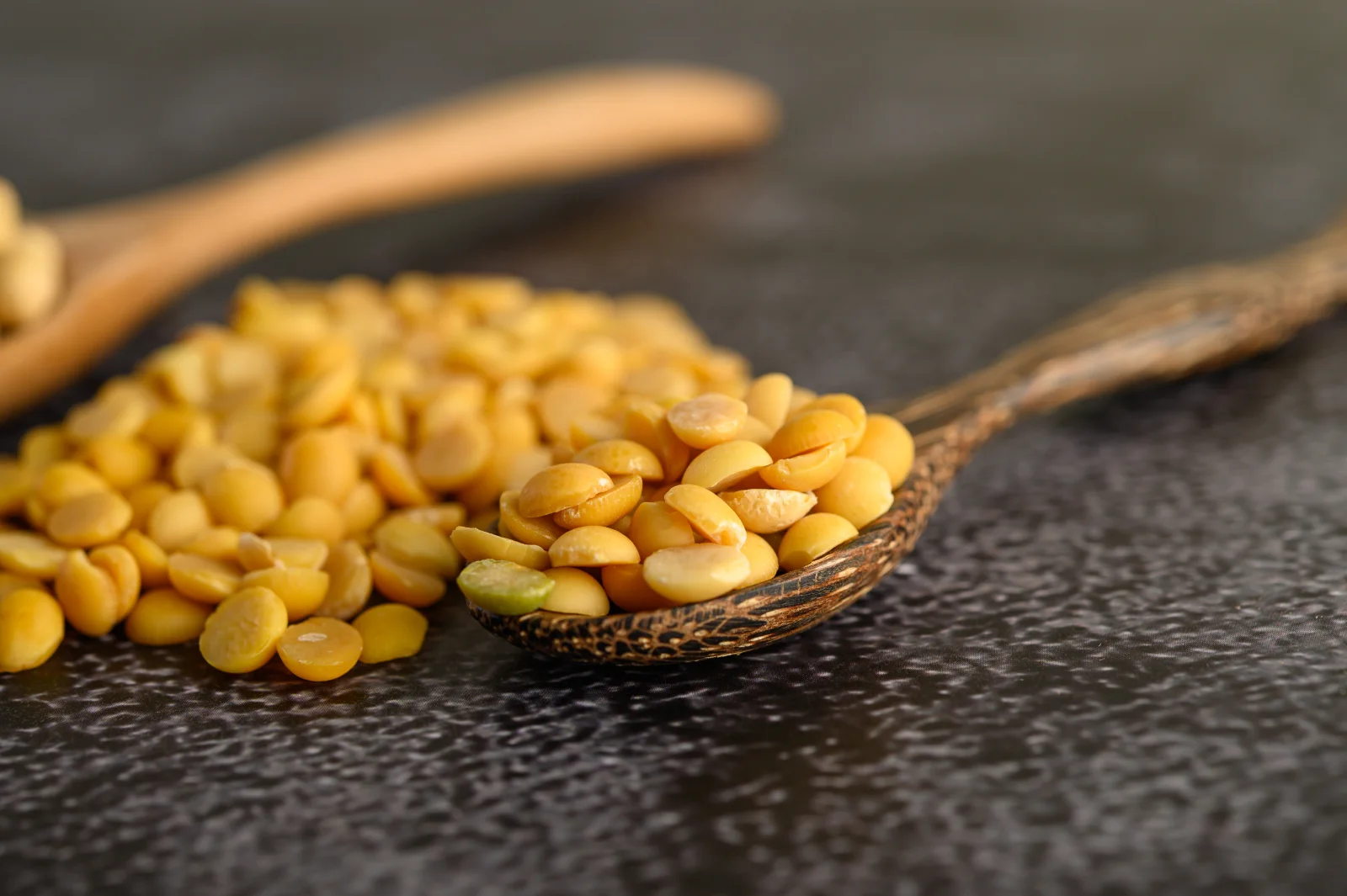 Yellow beans on a wooden spoon